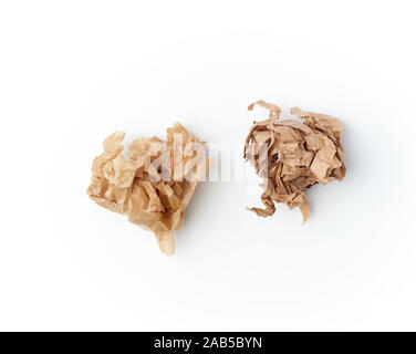 two crumpled sheets of brown paper on a white background, close up, top view Stock Photo
