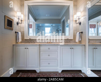 Beautiful bathroom interior with double sinks and marble counter, and large mirrors. Stock Photo