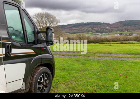 Single Swift Bessacarr Motorhome sits in a field near Llysfor on Anglesey overlooking Red Wharf Bay Stock Photo