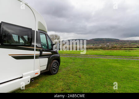 Single Swift Bessacarr Motorhome sits in a field near Llysfor on Anglesey overlooking Red Wharf Bay Stock Photo