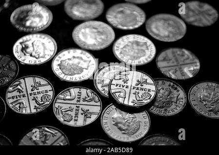 Five pence coins, on a black background Stock Photo