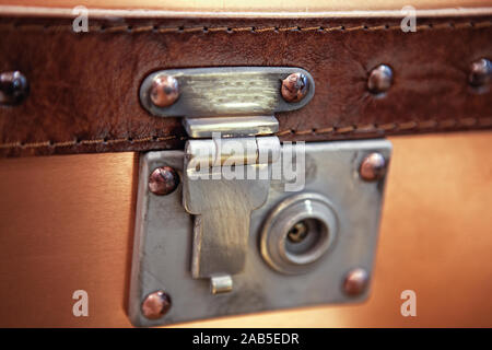 close-up fragment of locks and fasteners on the vintage leather suitcase brown Stock Photo