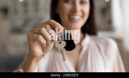 Female hand first home owner holding house key, closeup view Stock Photo