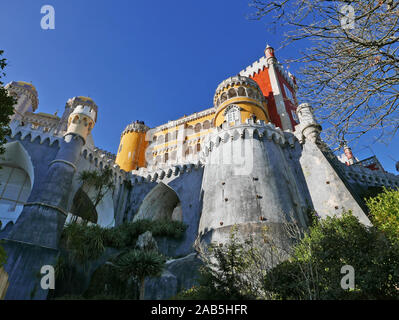 Looking upward toward one side of the castle at Sintra near Lisbon in Portugal known as the Pena Palace in São Pedro de Penaferrim Stock Photo