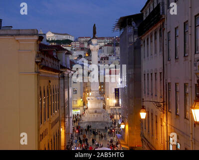 The Column of Pedro IV in Rossio Square (Praca de D. Pedro IV) at twilight in winter looking downward from Calcada do Carmo Stock Photo