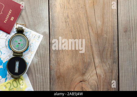 compass, map, passport lie on wooden boards. Stock Photo