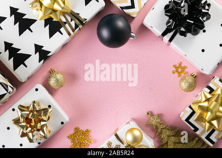 Selection of white, gold and black coloured christmas gift boxes Stock Photo