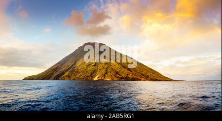 Panoramic view of Stromboli Island and the rainbow at sunset Stock Photo