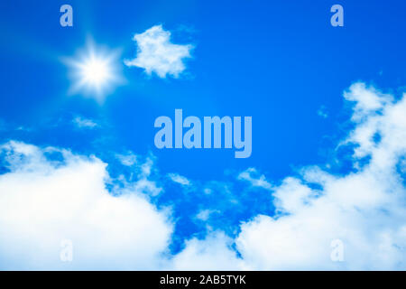 Ein wunderschoener blauer Himmel mit weissen Wolken und strahlender Sonne Stock Photo