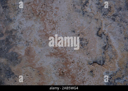 Wall of travertine with stone layers of different colors. Close up architecture macro photography. Creative wallpaper photography. Stock Photo