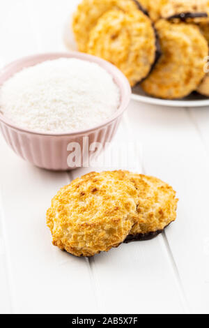 Coconut cookies with chocolate on white table. Stock Photo