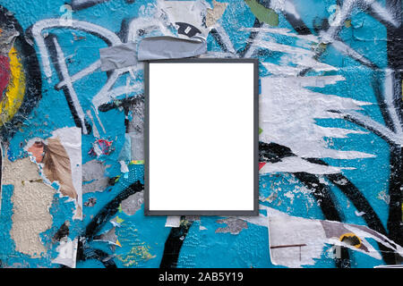 Blank notice advertising board for mockup on rough urban poster painted graffiti covered wall Stock Photo