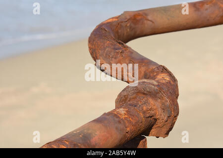 rusted water pipe on the seashore Stock Photo