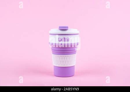Reusable coffee cup on pink background. Stock Photo