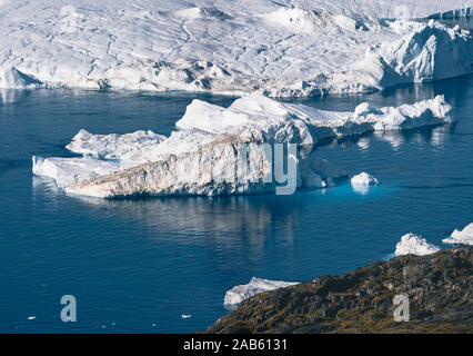 Iceberg and ice from glacier in arctic nature landscape in Ilulissat,Greenland. Aerial drone photo of icebergs in Ilulissat icefjord. Affected by Stock Photo