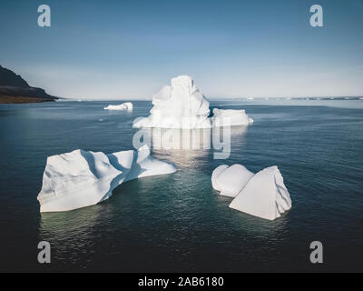 An Iceberg Of Colossal Size In The Form Of A Castle seen from above aerial. Floats In The Cold Waters Of Greenland in Arctica. Turquoise and blue Stock Photo