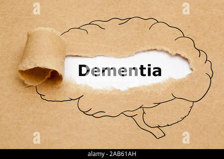 Word Dementia appearing behind ripped brown paper in human brain drawing. Stock Photo