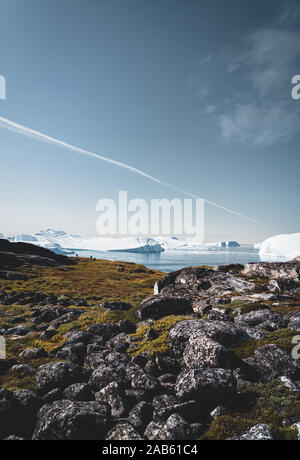 View towards Icefjord in Ilulissat. Easy hiking route to the famous Kangia glacier near Ilulissat in Greenland. The Ilulissat Icefjord seen from the Stock Photo