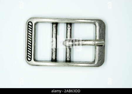 Square nickel-plated buckle with a flat tongue on a white background. Chrome metal fittings hardware for the manufacture of belts. Stock Photo