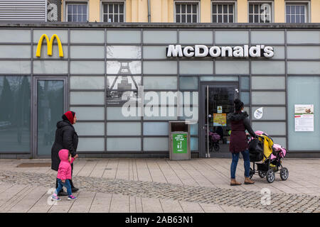 Central station of Herne Wanne-Eichel, McDonald's Fast Food Restaurant, picture of Pluto colliery in the facade, Stock Photo