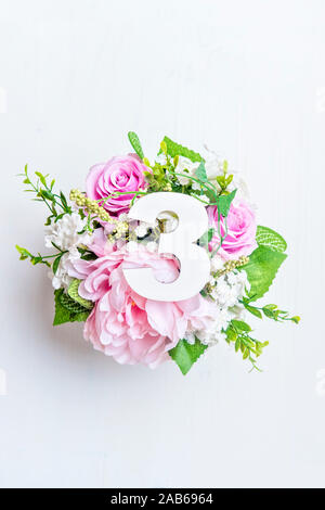 Layout with colorful flowers, leaves and number three. Flat lay. Top view. Stock Photo