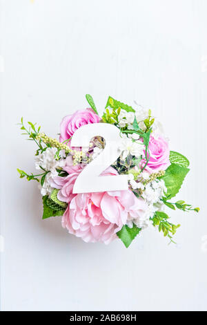 Layout with colorful flowers, leaves and number two. Flat lay. Top view. Stock Photo