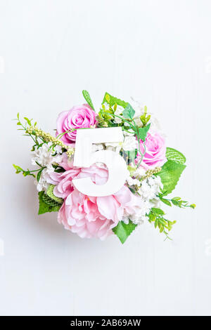 Layout with colorful flowers, leaves and number five. Flat lay. Top view. Stock Photo