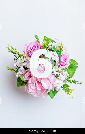 Layout with colorful flowers, leaves and number six. Flat lay. Top view. Stock Photo