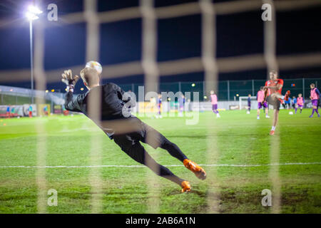 Goalkeeper catch the ball when defensive on goal during a football match Stock Photo