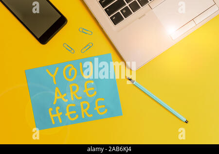 Conceptual hand writing showing You Are Here. Concept meaning This is your location reference point global positioning system Trendy open laptop smart Stock Photo