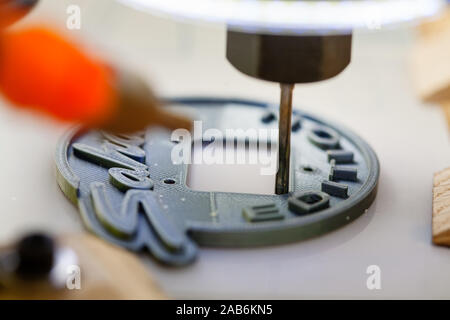 Using CAD to precisely control the cutting of a design out of plastic material. Stock Photo