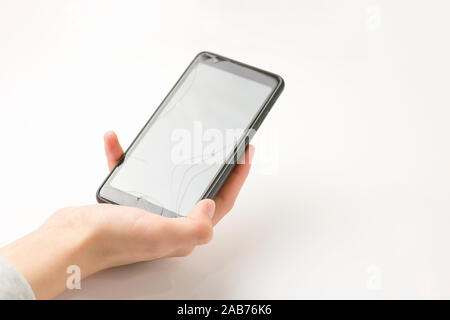 Smartphone in hand on a white background. Broken screen Stock Photo