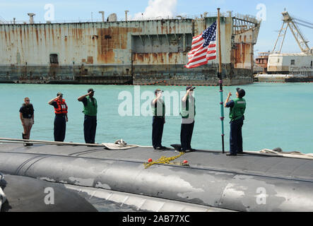 APRA HARBOR, Guam (April 15, 2013) Sailors aboard the Los Angeles-class attack submarine USS Charlotte (SSN 766) shift colors after the submarine moors in Apra Harbor to conduct maintenance and liberty. Stock Photo