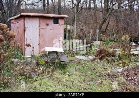 Shack of an unemployed beggar in the forest made of trash and old   linoleum Stock Photo