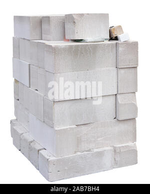Large white bricks foam concrete blocks heap for the construction of a residential village house. Isolated pn white Stock Photo