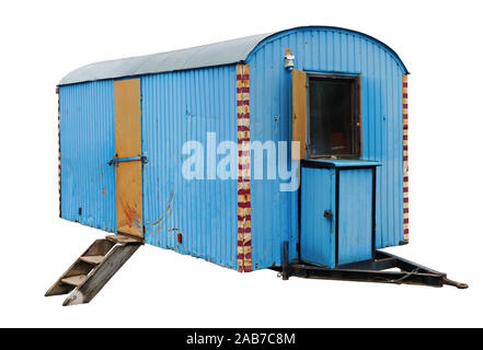 An old aged steel blue trailer was once used to transport circus artists. Iisolated  vintage outdoor object