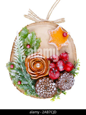 Christmas homemade decoration toy  in rustic style made  of dry red orange rose cones and red  berries on a wooden  slice. Isolated with patch on whit Stock Photo