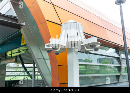 Outdoor surveillance CCTV digital video monitoring cameras to observe and record footage of public places. Photo taken when it's drizzling. Stock Photo