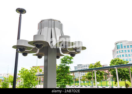 Outdoor surveillance CCTV digital video monitoring cameras to observe and record footage of public places. Photo taken when it's drizzling. Stock Photo