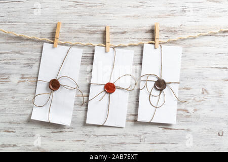 White envelopes hanging on rope Stock Photo