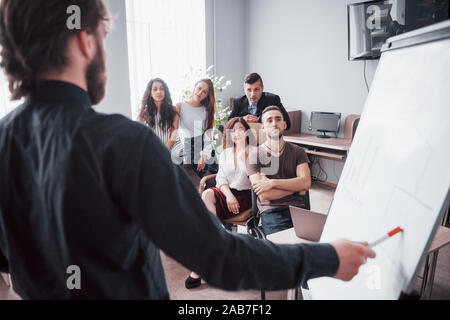 Happy young colleagues discussing in meeting at creative office Stock Photo
