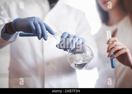 Experiments in the chemical laboratory. An experiment was carried out in a laboratory in transparent flasks Stock Photo