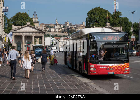 Italy, Bergamo, Lombardy: pedestrians and bus to the airport in the lower city Stock Photo