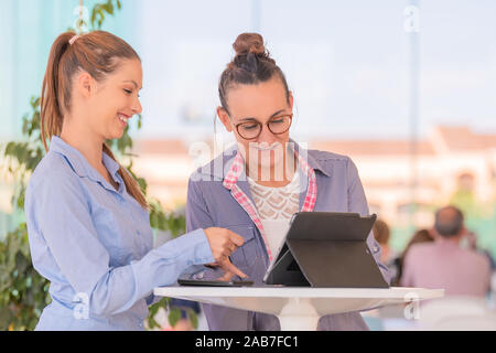 Two women using tablet computer Stock Photo