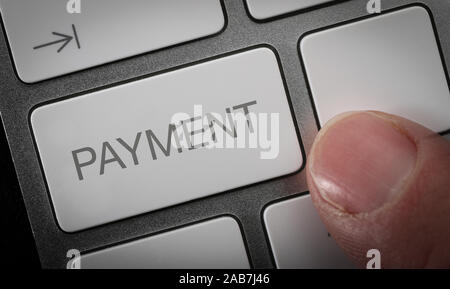A man pressing a key on a computer keyboard with the word pay. online payment concept image. Stock Photo
