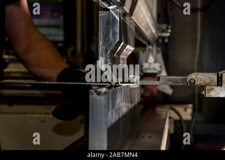 operator bending metal sheet by sheet bending machine bending of metal Stock Photo
