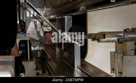 operator bending metal sheet by sheet bending machine bending of metal Stock Photo