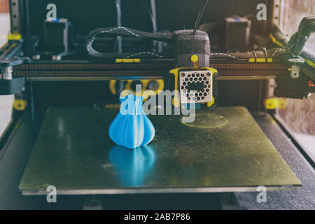 Modern 3d printer with printed three dimentional model of vase at home, Stock Photo