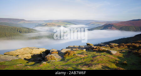 Early morning fog lingering above the Ladybower Reservoir in the valley below Bamford Edge, Peak District, Derbyshire, England, United Kingdom, Europe Stock Photo