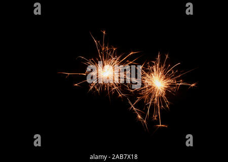Two sparklers firework on black background. Christmas celebration. Stock Photo